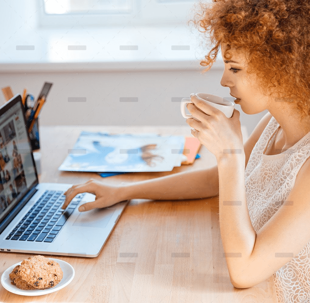 demo-attachment-493-woman-photographer-drinking-coffee-and-working-PJNBP6U